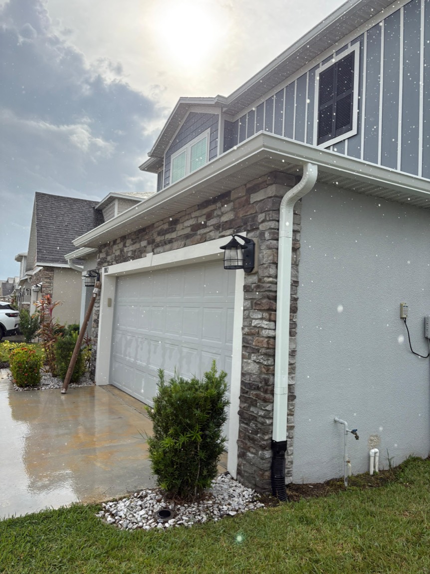 Gutter downspout beside the garage of a two-story home